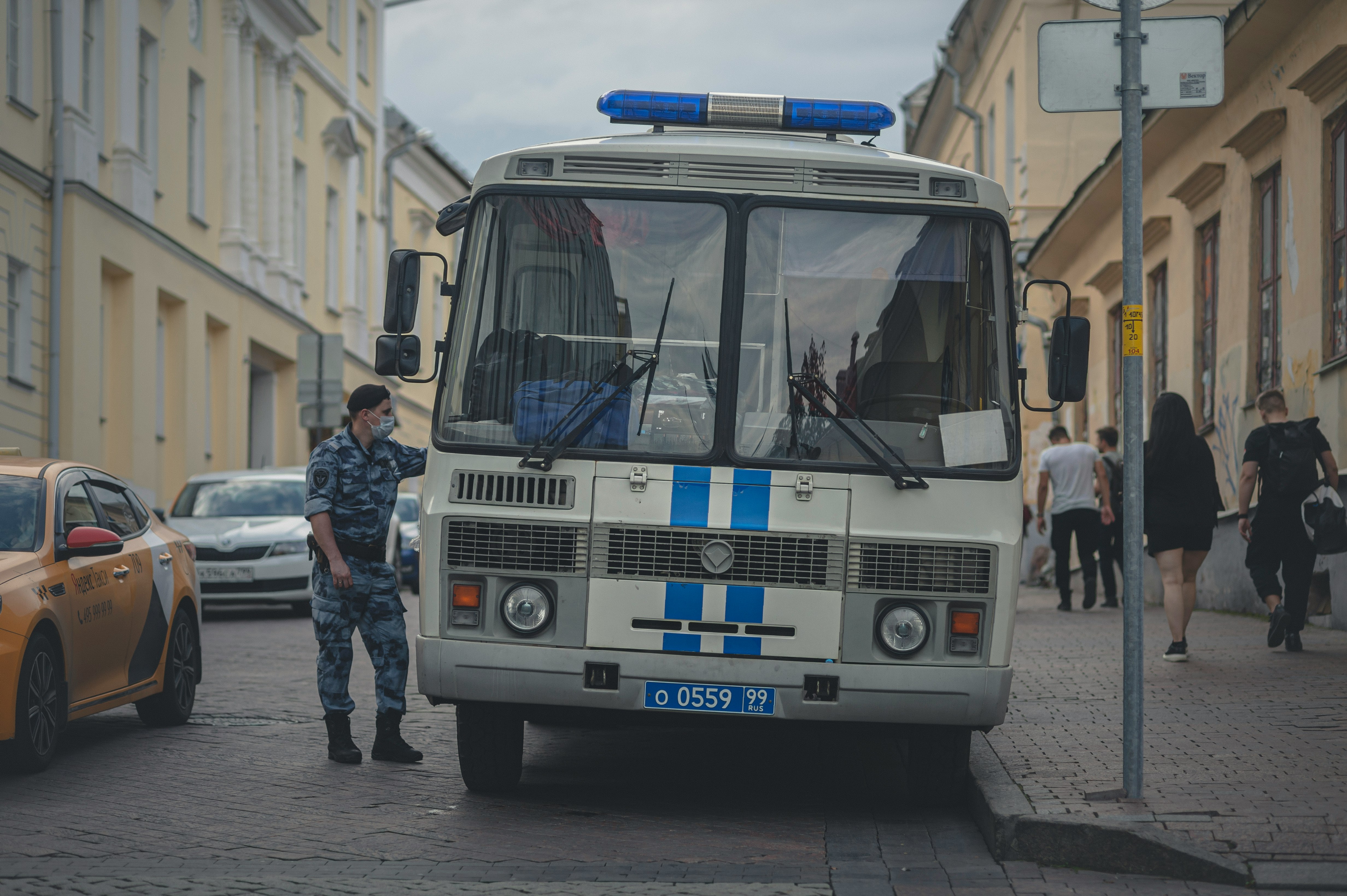 white and blue bus on road during daytime